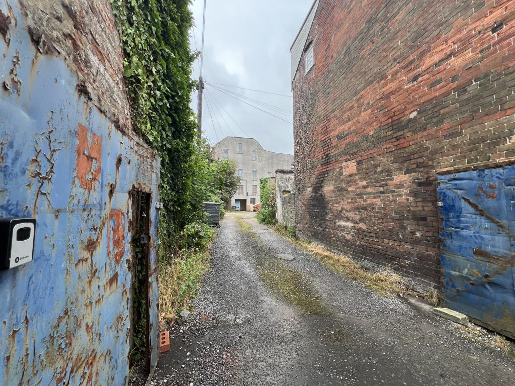 Lot: 100 - FORMER TRANSPORT YARD WITH POTENTIAL - View of entrance to the site showing access